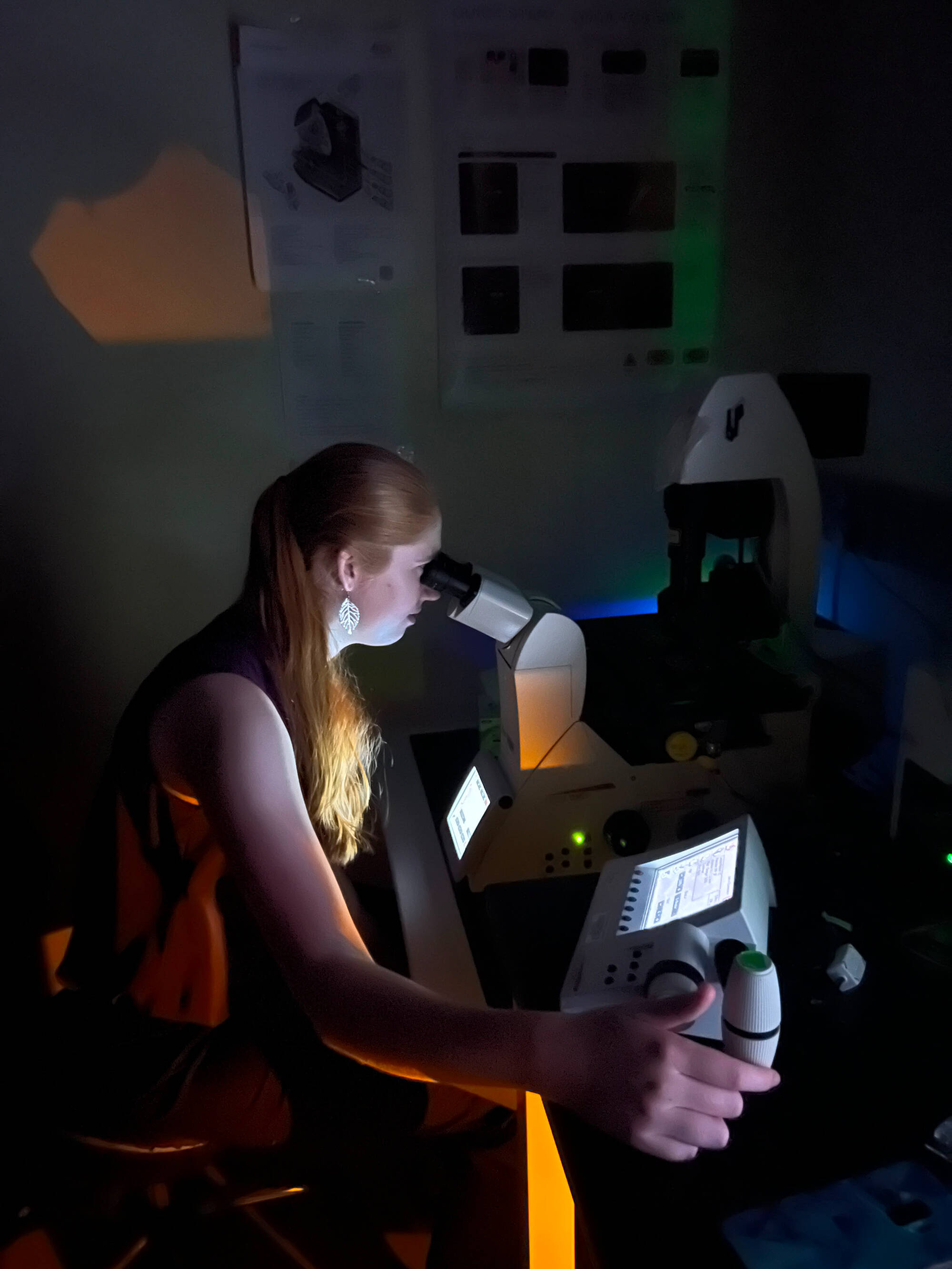 Bri using a confocal microscope during summer internship.